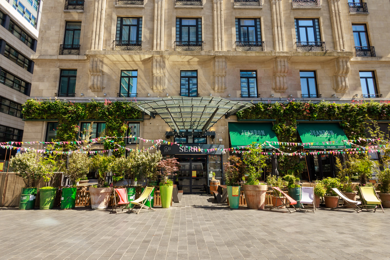A planted outdoor dining terrace at SERRA Brussels